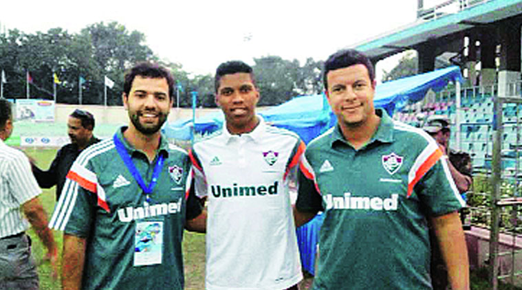 Romulado (C) alongside his coaches from the Santo Antonio school team.