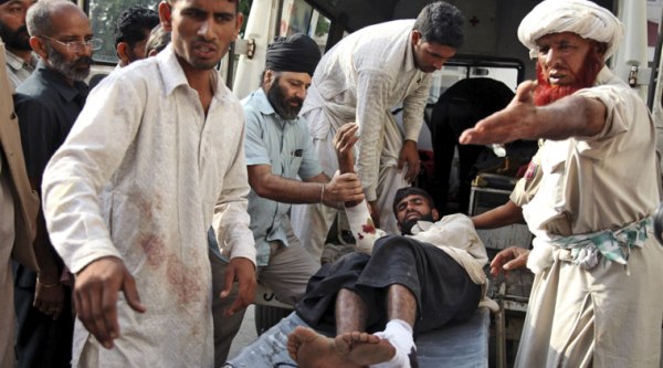 An injured man is brought on a stretcher for treatment at the government medical college hospital following firing by Pakistani troops across the India Pakistan border at Jora farm in Jammu. (Source: AP photo)