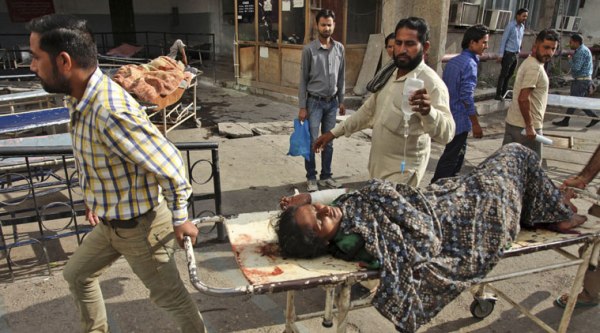 A woman is brought to a government medical college hospital after she was injured in firing by Pakistani troops across LoC. (Source: AP photo)