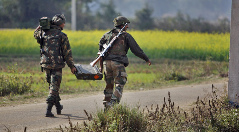 Indian Army soldiers carry arms and ammunition near the site of exchange of gunfire with armed suspected militants at Pindi Khattar village in Arnia border sector, 43 kilometers (27 miles) south of Jammu, India, Thursday, Nov. 27, 2014. An army officer says some of the militants occupied an abandoned bunker in Jammu region early Thursday and fired at the soldiers in Arnia sector in the Indian portion of Kashmir. (Source: AP Photo/Channi Anand)