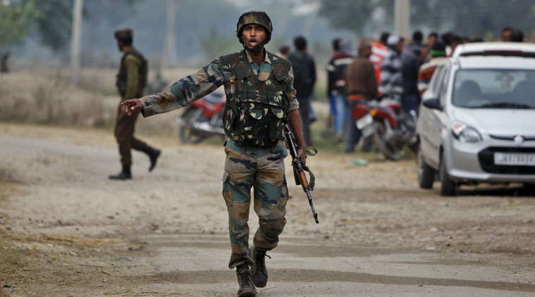 An Indian Army soldier gives orders to his colleagues during exchange of gunfire with armed suspected militants at Pindi Khattar village in Arnia border sector, 43 kilometers (27 miles) south of Jammu, India, Thursday, Nov. 27, 2014. An army officer says some of the militants occupied an abandoned bunker in Jammu region early Thursday and fired at the soldiers in Arnia sector in the Indian portion of Kashmir. (AP Photo/Channi Anand)