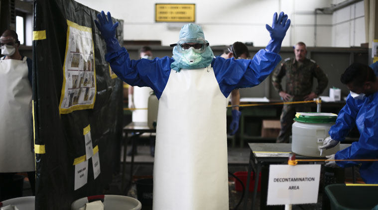 A volunteer of the German forces Bundeswehr gets sprayed a bleach mixture on his protective suit during a training for the Ebola virus in Appen about 25 kilometers (15,5 miles) north of Hamburg, Germany, Thursday, Oct. 23, 2014. The volunteers of the German forces Bundeswehr get trained for a mission to support the German Red Cross in Liberia in the fight against the Ebola epidemic. (Source: AP)