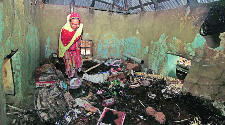 A TMC supporter grieves as she searches for her belongings after her house was torched in a political clash, at Jadavpur village, in Birbhum on Thursday. (Source: PTI photo)