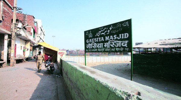 The ‘desecrated’ mosque; A mata ki chowki can be seen behind the policeman. ( Source: Express photo by Amit  Mehra )