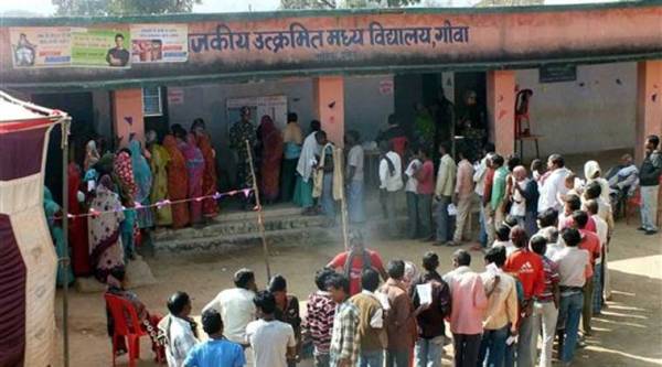People wait to cast votes at a polling station during the first phase of Jharkhand Assembly elections in Latehar on Tuesday. (PTI Photo)