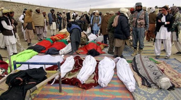 Bodies of victims killed from Sunday's suicide attack are laid on the ground in the Yahyakhail district of Paktika province east of Kabul, Afghanistan, Monday, Nov. 24, 2014. (AP Photo)