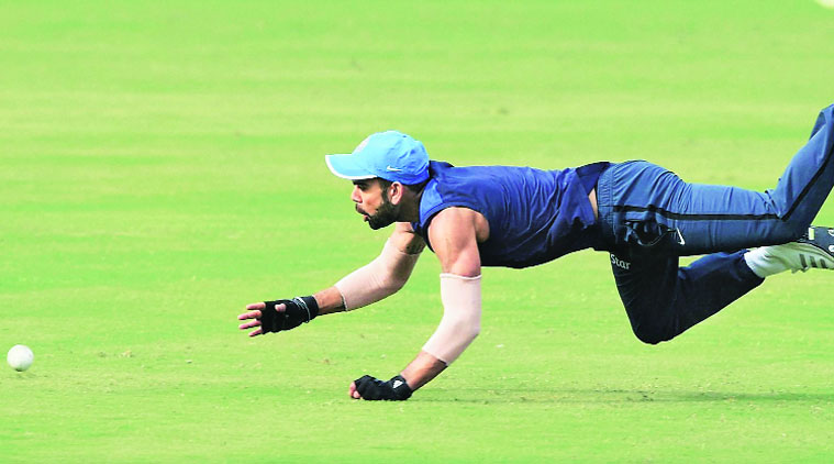 Team India skipper Virat Kohli dives to stop a ball during a training session in Cuttack on Saturday. (PTI)