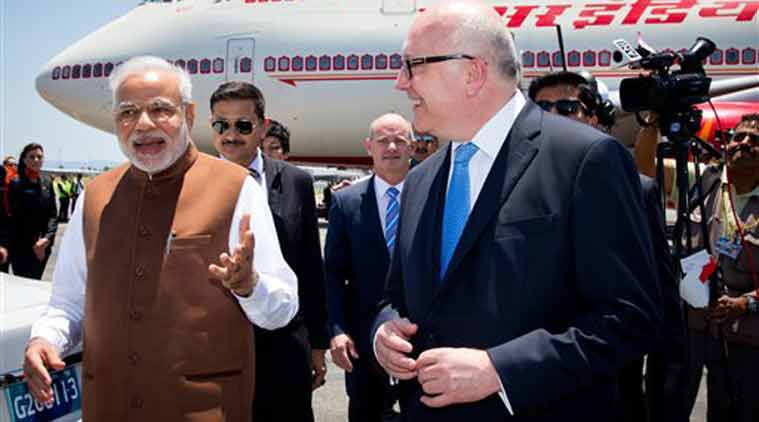 PM Narendra Modi walks with Australia's Attorney-General George Brandis on his arrival at Brisbane Airport ahead of the G-20 summit in Brisbane, Australia on Friday. (Source: AP photo)