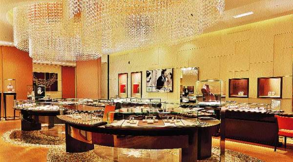 The Murano chandelier, made out of 5,500 pieces of crystal, has been assembled by hand to allow a cascade of light in the store.