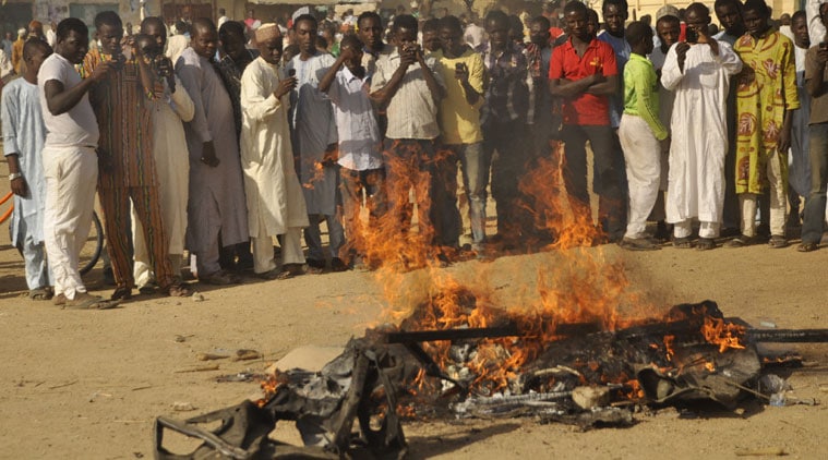 People gather at the site of a bomb explosion in Kano, Nigeria, on Friday. (Source: AP photo)
