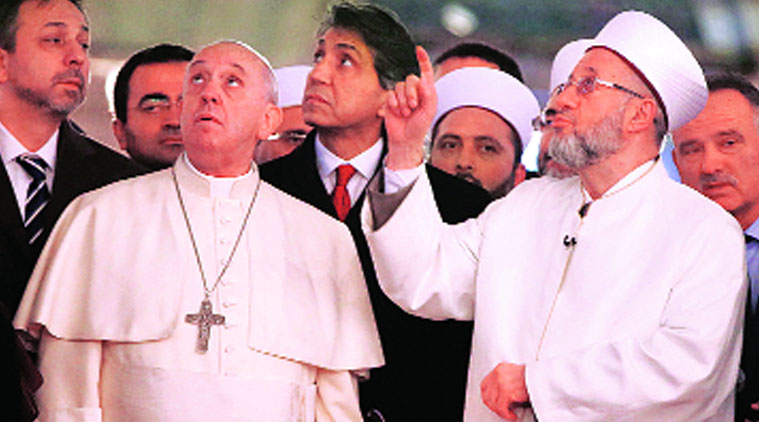 Pope Francis listens to the Mufti of Istanbul, Rahmi Yaran (right), during a visit to the Blue Mosque in Istanbul on Saturday. (Source: Reuters photo)