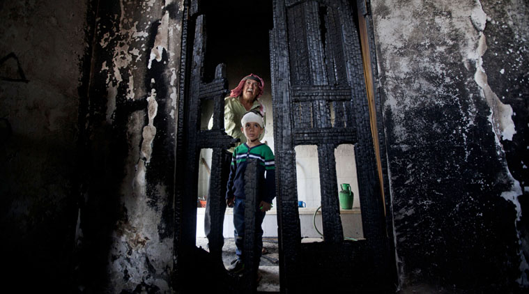 Palestinians inspect damages of a mosque following an attack in the West Bank village of Mughayer, north of Ramallah.