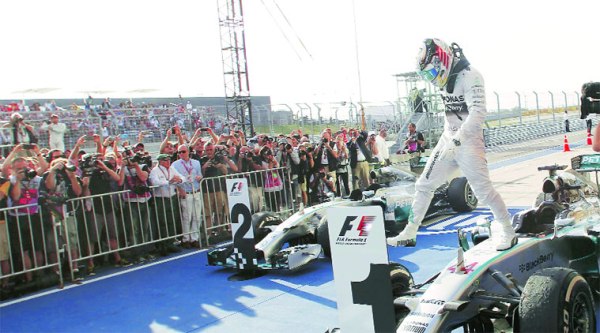walk on crowds: Lewis Hamilton exits his vehicle after winning the US Grand Prix on Sunday. He now has 316 points this season. (Reuters)
