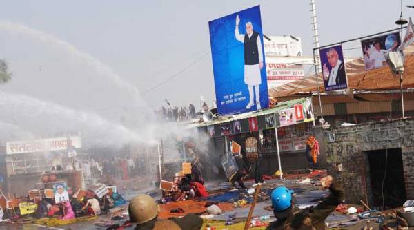  Police use batons and water cannon to disperse Sant Rampal supporters, as they storm the ashram in Hisar, Haryana state on Tuesday, Nov.18, 2014. (AP Photo)
