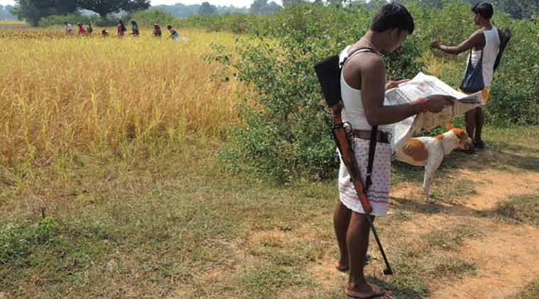 Dhaneshwar Gope stands with a .315 rifle slung across his shoulder. (Source: Express photo by Manas Chaudhary)