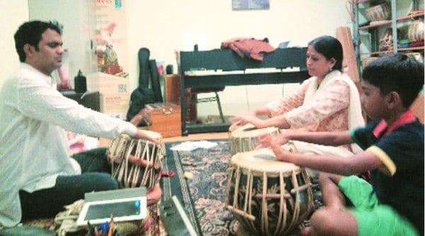 Prashanthi, along with her son Jagannath, takes tabla lessons at Temple of Fine Arts.