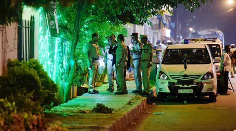 Police officials on spot where a low intensity bomb blast occurred at church street in Bengaluru on Sunday night. (Source photo: PTI )