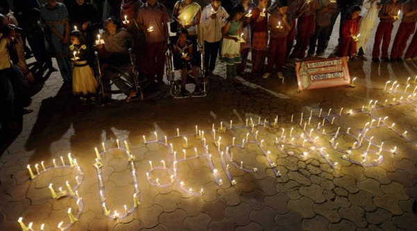 Victims of the Bhopal Gas Tragedy take part in a candle lit vigil to mark the 30th anniversary of the tragedy in Bhopal on Sunday. (Source: PTI Photo)