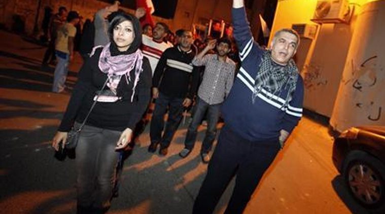 Zainab al-Khawaja (front L), daughter of human rights activist Abdulhadi al-Khawaja, and fellow human rights activist Nabeel Rajab (R) take part in a rally held in support of Abdulhadi al-Khawaja in the village of Bani-Jamra, west of Manama March 11, 2012. (Source: Reuters)
