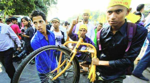 A handicapped person protests with his broken cycle at Rani Rashmoni Avenue, in Kolkata on Wednesday. (Source: Express photo by Subham Dutta)