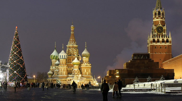 In this Thursday, Dec. 10, 2009 file photo people walk past a huge Christmas tree installed in Red Square, with St. Basil Cathedral. (Source: AP Photo/Misha Japaridze, File)
