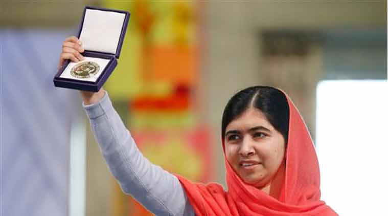 Nobel Peace Prize winners Malala Yousafzai from Pakistan holds up her medal during the Nobel Peace Prize award ceremony in Oslo (Source: AP)
