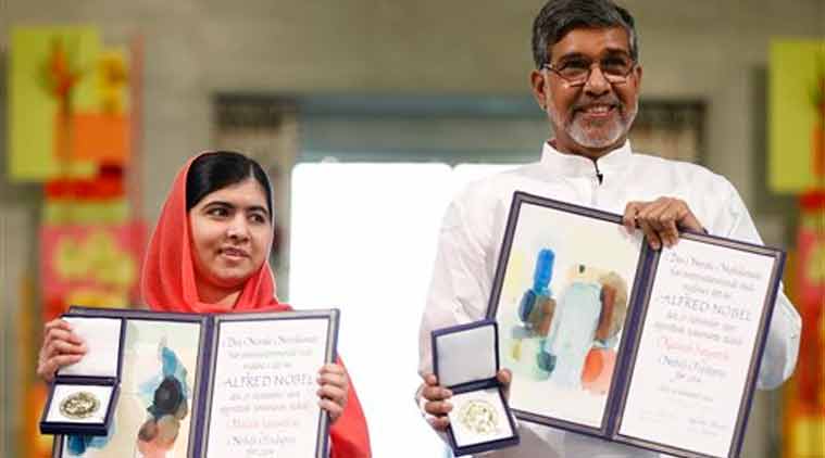 Nobel Peace Prize winners Malala Yousafzai from Pakistan and Kailash Satyarthi of India hold their Nobel Peace Prize diplomas and medals during the Nobel Peace Prize award ceremony in Oslo (Source: AP)
