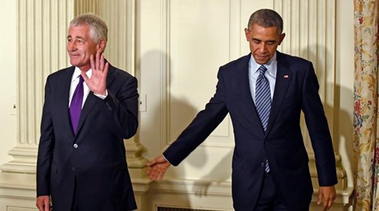 This Nov. 24, 2014, file photo shows President Barack Obama, right, reaching to Defense Secretary Chuck Hagel, left, following an announcement of Hagel's resignation during an event in the State Dining Room of the White House. (Source:AP)