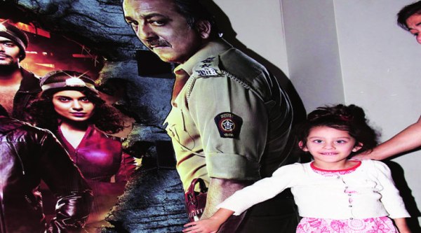 Iqra Dutt poses next her dad’s poster