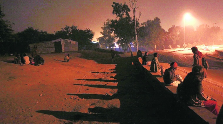 People outside night shelters near ISBT in Kashmere Gate. Some said they would rather be cold than step inside the filthy tents. (Source: Express photo by Praveen Khanna)