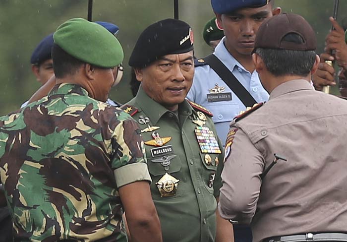 Indonesian Armed Forces Chief, Gen. Moeldoko, center, acknowledges others upon arrival following a search operation for the victims of AirAsia Flight 8501 at the airport in Pangkalan Bun, Indonesia, Tuesday, Jan. 6, 2015.(AP Photo/Achmad Ibrahim)