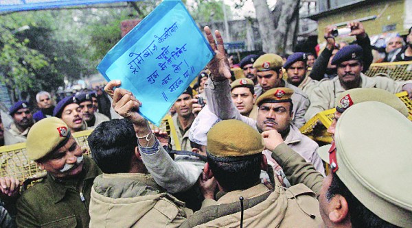 A protester challenges Kejriwal to a debate.