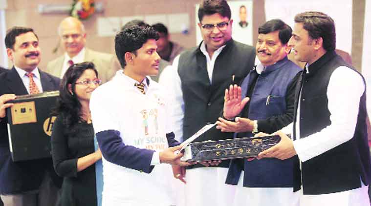 Akhilesh along and uncle Shivpal Yadav distributes laptops to beneficiaries under Uttar Pradesh Kaushal Vikas Mission at his official residence, in Lucknow. ( Source: Express Photo by Vishal Srivastav)