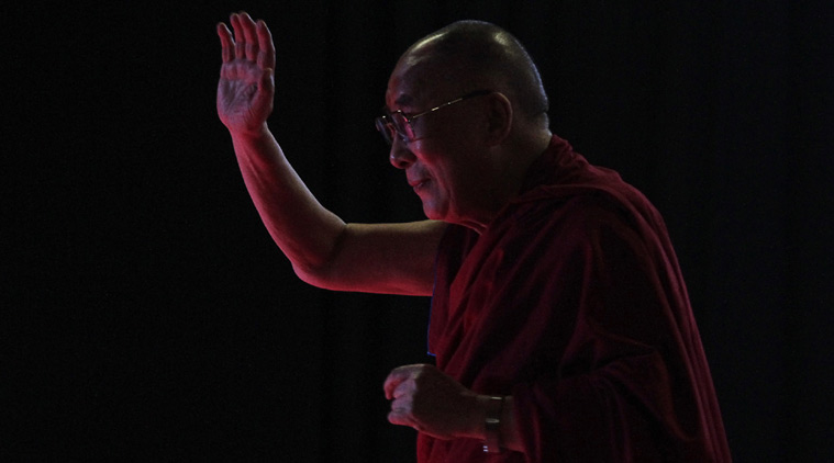 Tibetan spiritual leader the Dalai Lama greets the audience as he arrives to speak on "A Human Approach to World Peace" at Presidency University in Kolkata, India, Tuesday, Jan. 13, 2015. (AP Photo/Bikas Das)