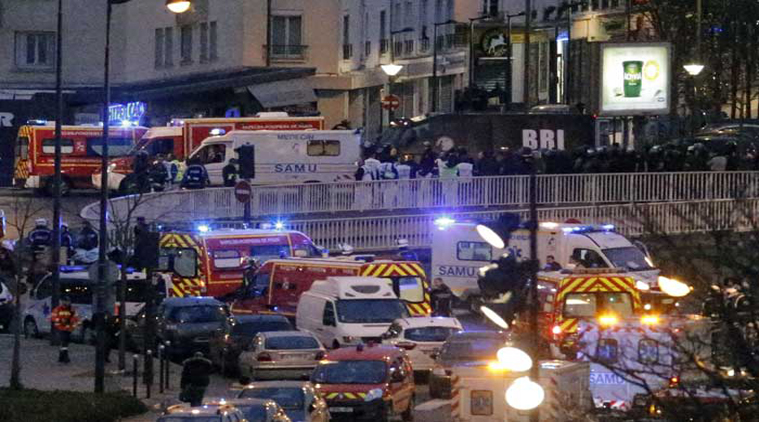 Police officers and rescue workers gather after police stormed a kosher grocery store where a gunman held serveal hostages, in Paris. (Source: AP photo)