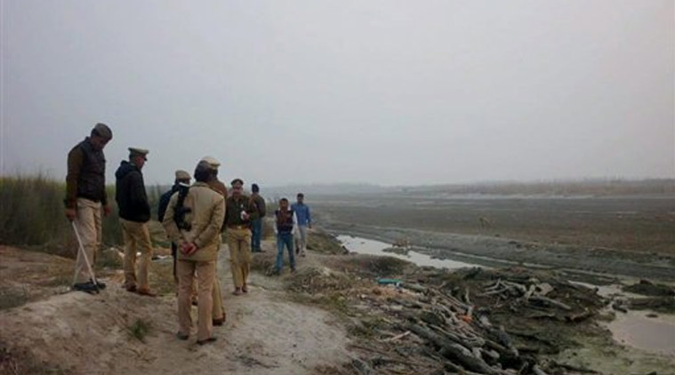 Policemen inspecting the site at Shafipur in Unnao district of Uttar Pradesh where dead bodies were seen floating in river Ganga on Tuesday. (Source: PTI)