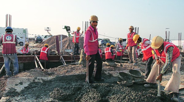 Migrants at work in a village in Sanand