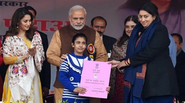 Prime Minister Narendra Modi with Union HRD Minister Smriti Irani presenting the Sukanya Samriddhi account pass-book to a girl during its launch at Beti Bachao Beti Padhao programme in Panipat on Thursday. Actress Madhuri Dixit is also seen. (PTI Photo)