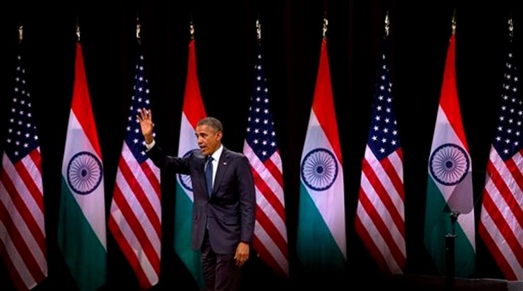 U.S. President Barack Obama waves to the gathering after delivering a speech at the Siri Fort Auditorium, a government-run event center, in New Delhi on Tuesday, Jan. 27, 2015. (AP Photo)