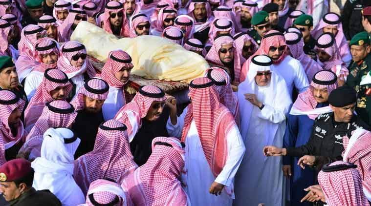 In this Friday, Jan. 23, 2015 photo, provided by the Saudi Press Agency, Saudi's newly enthroned King Salman, center left, helps carry the body of King Abdullah, who died early Friday at age 90 during his funeral in Riyadh, Saudi Arabia. In line with the strict interpretation of Islamic tradition observed in the kingdom, Abdullah was buried in an unadorned, beige cloth without a coffin in an unmarked grave. World leaders and top dignitaries began arriving in Saudi Arabia on Saturday to give their condolences following the death of King Abdullah after nearly two decades at the helm. (AP Photo/SPA)