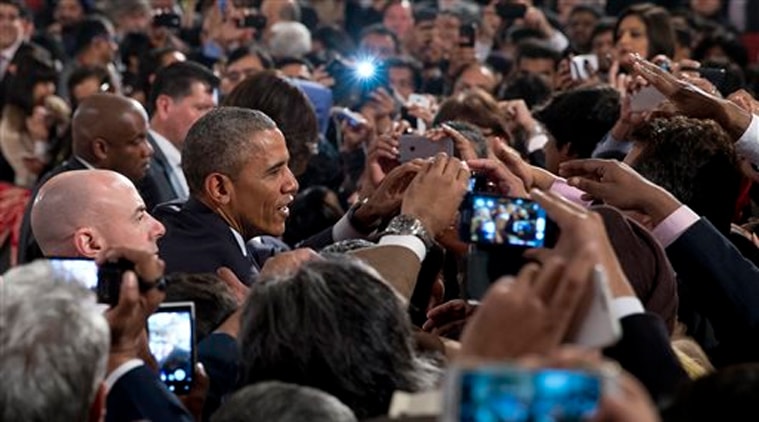 President Barack Obama greets people in the audience after speaking at the Siri Fort Auditorium in New Delhi on Tuesday, Jan. 27, 2015. (AP Photo)