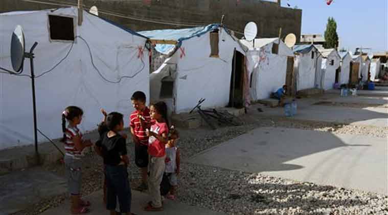 In this photo, Syrian refugee children play outside their tent in a Syrian refugee camp in the eastern town of Marj, Bekaa valley, Lebanon. (Source: AP)
