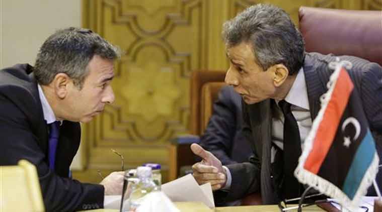 Libyan representative at the Arab League Ashour Abu-Rashed, right, talks to his Egyptian counterpart Tarek Adel, during an emergency representatives meeting to discuss the conflict in Libya, at the Arab League headquarters in Cairo, Egypt, Monday. (Source: AP)