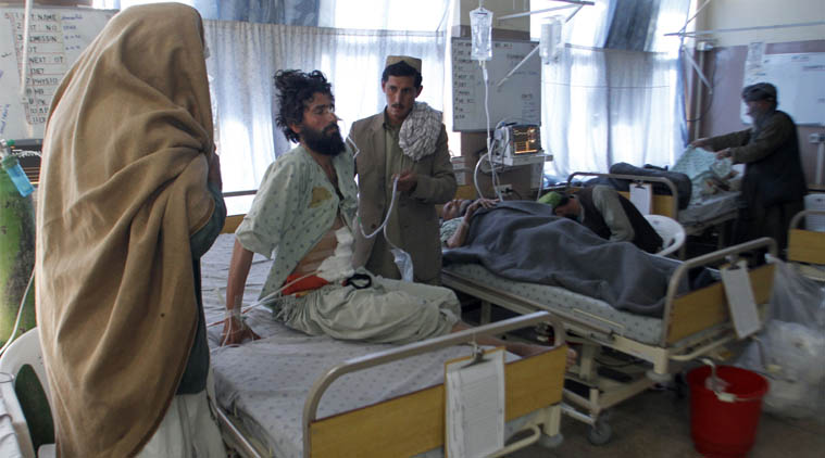 File. An Afghan wounded man, second left, sits on a bed at the main hospital, in the city of Kandahar, south of Kabul, Afghanistan. (AP Photo)