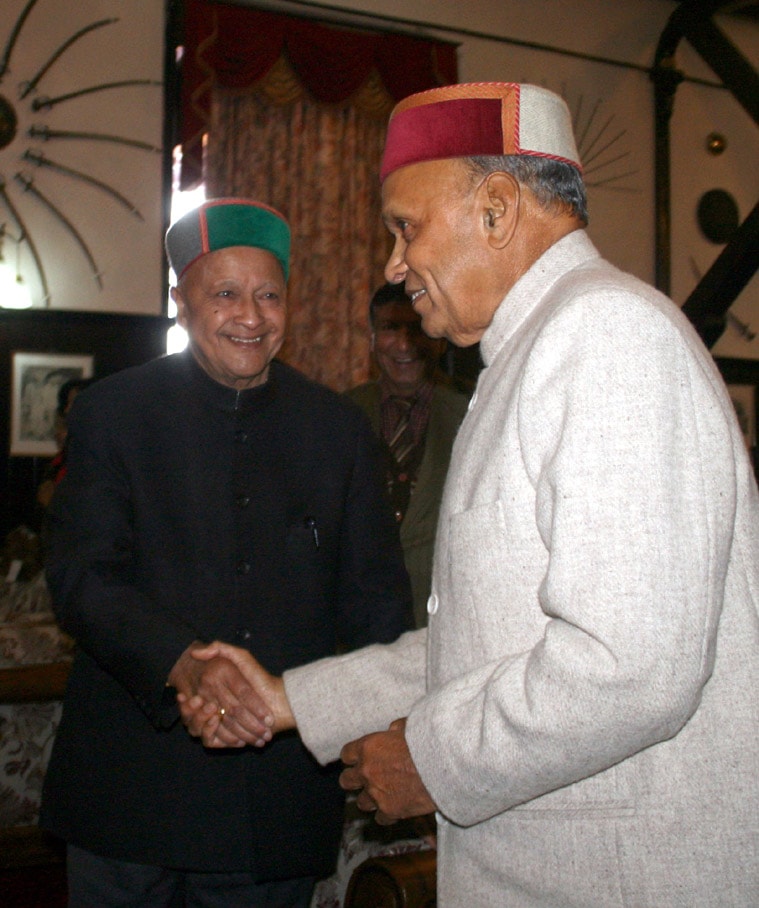 Chief Minister Virbhadra Singh shakes hands with former Chief Minister and leader of opposition Prem Kumar Dhumal during the oath ceremony of Kalyan Singh Governor at Raj Bhawan in Shimla on Wednesday. (Source: Express photo by Lalit Kumar)