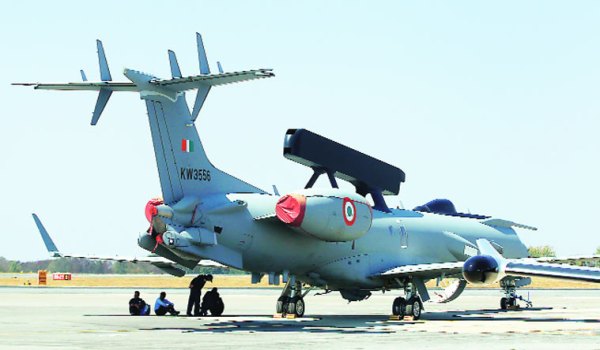 Engineers and support staff sit beside an Embraer EMB-145I aircraft during rehearsals for Aero India in Bangalore Tuesday. (AP)