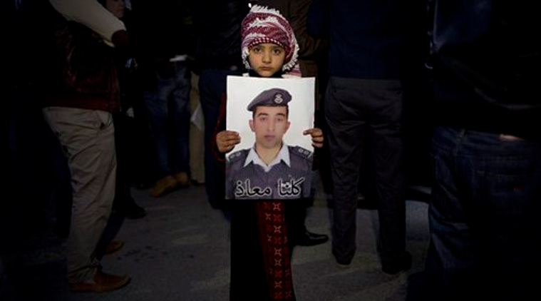 Jordanian child holds a poster with a picture of Jordanian pilot, Lt. Muath al-Kaseasbeh.(Source: AP)