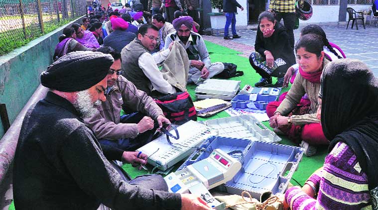 EVMs being distributed on the eve of elections at Shivalik School. ( Source: Express Photo)