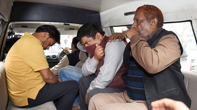 Police take away accused in Petroleum Ministry document leak, from Shastri Bhavan in New Delhi on Friday. (Source: PTI Photo)