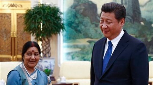Sushma Swaraj, left, and Chinese President Xi Jinping wait for the arrival of Indian delegation members before starting a meeting at the Great Hall of the People in Beijing on Monday, Feb. 2, 2015. (AP Photo)